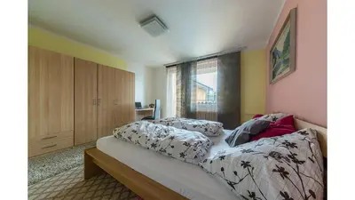 a bedroom with a bed and a window at Apartmán Vrané in Vrané nad Vltavou