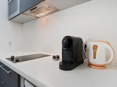 a kitchen counter with a microwave and a toaster at Apartment Golden Stage Nook by Interhome in Prague