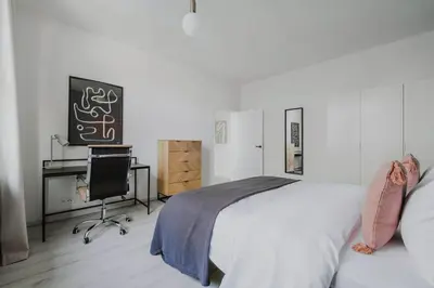 a bedroom with a bed and a desk and a chair at Blueground Prague 10 equipped VŠFS University PRG-28 in Prague