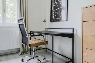 a black desk with a chair in a room at Blueground Prague 10 equipped VŠFS University PRG-28 in Prague