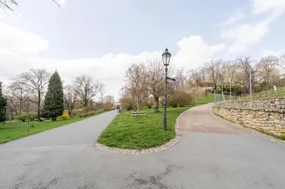 a walkway in a park with a street light at Blueground Prague 10 equipped VŠFS University PRG-28 in Prague