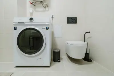 a bathroom with a washing machine and a toilet at Blueground Prague 10 equipped VŠFS University PRG-28 in Prague