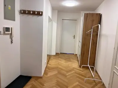 a hallway with a door and a wooden floor at Modern apartment in the city centre in Prague
