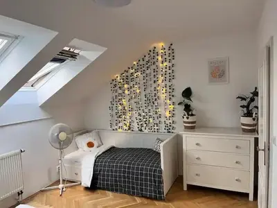 a room with a bed and a dresser in a attic at Modern apartment in the city centre in Prague