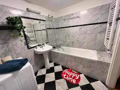 a bathroom with a white tub and a sink and a bath tub at Modern apartment in the city centre in Prague