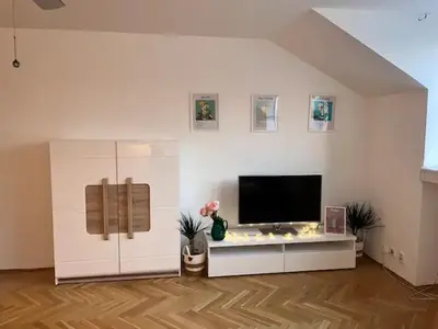a living room with a television on a white wall at Modern apartment in the city centre in Prague