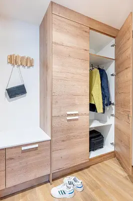 a closet with a wooden door and a pair of shoes at Radlické výhledy in Prague