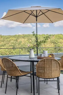 a table and chairs with an umbrella on a balcony at Radlické výhledy in Prague