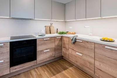 a kitchen with wooden cabinets and a plate of oranges on the counter at Radlické výhledy in Prague