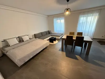 a bedroom with a bed and a table and a couch at Byt apartman 72m2 private garden PARKING FREE in Prague