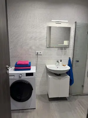 a bathroom with a washing machine and a sink at Byt apartman 72m2 private garden PARKING FREE in Prague