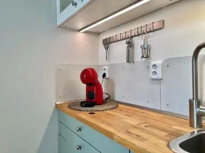 a red appliance sitting on top of a kitchen counter at Sunlit - Prague Apartment in Prague