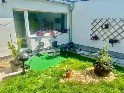 a patio with green grass and a table and chairs at Dolpo 55 in Benešov