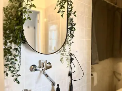 a bathroom sink with a mirror and a faucet at Wenceslas - Prague Apartment in Prague