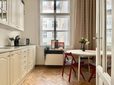 a kitchen with a table and chairs and a window at Wenceslas - Prague Apartment in Prague