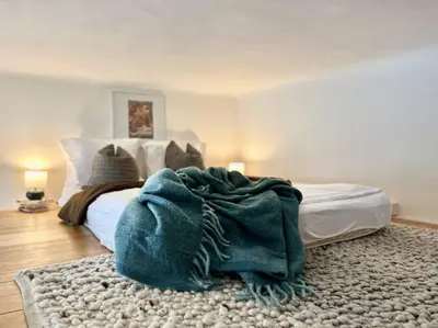 a bedroom with a large white bed and a mirror at Wenceslas - Prague Apartment in Prague