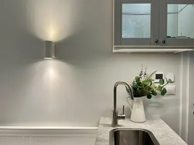 a kitchen counter with a sink and a wine glass at Pine - Prague Apartment in Prague