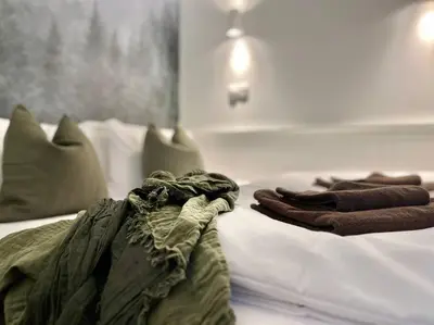 a hotel room with two beds with towels on them at Pine - Prague Apartment in Prague