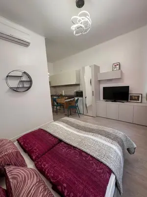 a bedroom with a large bed and a living room at 8- Little Prague Home in Prague