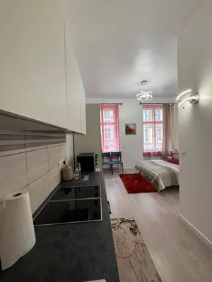 a room with a kitchen and a bed in it at 8- Little Prague Home in Prague