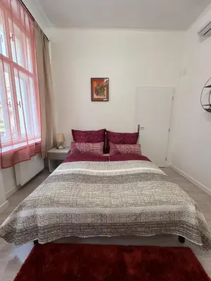 a bedroom with a large bed in a white room at 8- Little Prague Home in Prague