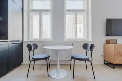 a kitchen with a table and two chairs at Blueground Žižkov nr University of Economics PRG-36 in Prague