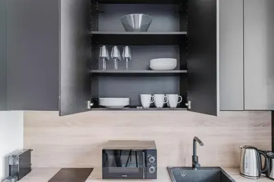 a kitchen with a sink and a microwave at Blueground Žižkov nr University of Economics PRG-36 in Prague