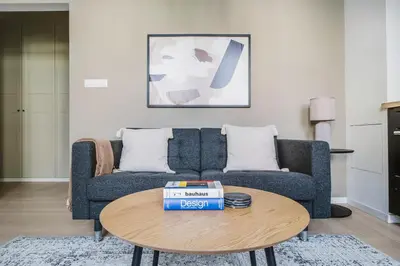 a living room with a blue couch and a table at Blueground Žižkov nr University of Economics PRG-36 in Prague