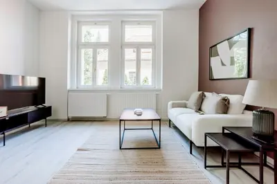 a living room with a white couch and a table at Blueground Rostovska str renovated furnished PRG-19 in Prague