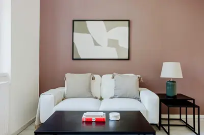 a living room with a white couch and a table at Blueground Rostovska str renovated furnished PRG-19 in Prague