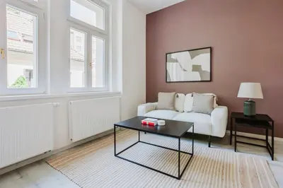 a living room with a couch and a coffee table at Blueground Rostovska str renovated furnished PRG-19 in Prague