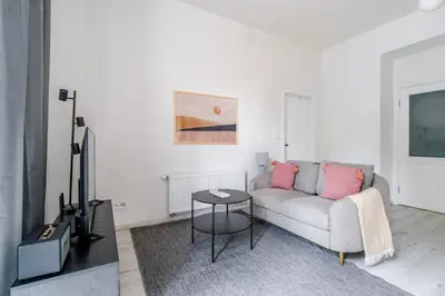 a living room with a couch and a table at Blueground Vršovice private terrace equipped PRG-4 in Prague