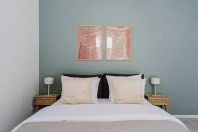 a bedroom with a bed with two side tables at Blueground Vršovice private terrace equipped PRG-4 in Prague