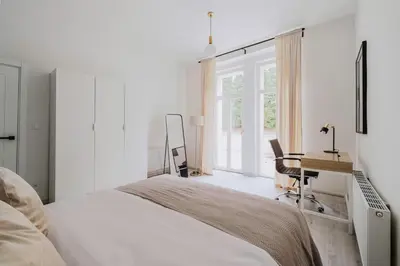 a bedroom with a bed and a desk and a window at Blueground Vršovice private terrace equipped PRG-4 in Prague