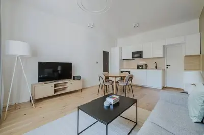 a living room with a couch and a table at Blueground Prague 3 shopping close to offices PRG-20 in Prague