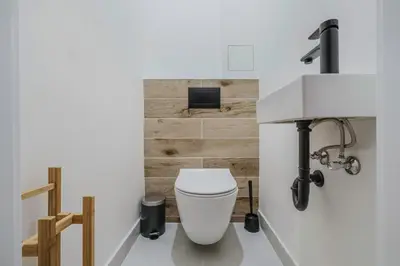 a bathroom with a white toilet and a sink at Blueground Prague 3 shopping close to offices PRG-20 in Prague
