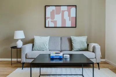 a living room with a couch and a coffee table at Blueground Prague 3 shopping close to offices PRG-20 in Prague