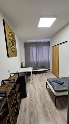 a room with three beds and a chalkboard on the wall at Ubytovna-Hostel- IMOS in Prague