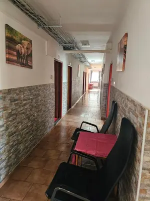 a dining room with a red table and chairs at Ubytovna-Hostel- IMOS in Prague