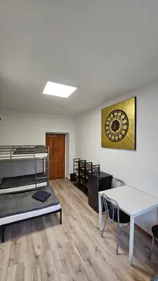 a dorm room with bunk beds and a table at Ubytovna-Hostel- IMOS in Prague