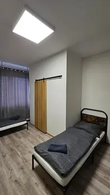 a bedroom with a bed in a room with a window at Ubytovna-Hostel- IMOS in Prague