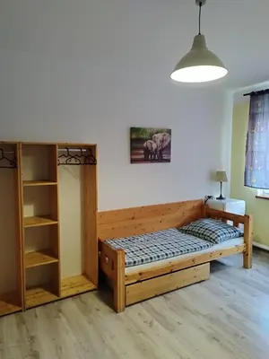 a bedroom with a bed and a book shelf at Ubytovna-Hostel- IMOS in Prague