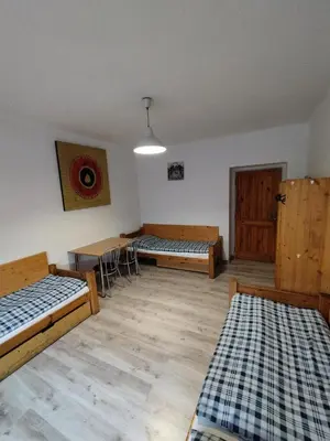 a room with two beds and a table in it at Ubytovna-Hostel- IMOS in Prague