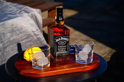 a bottle of whiskey and two glasses on a table at Tiger Deluxe Suite in Prague
