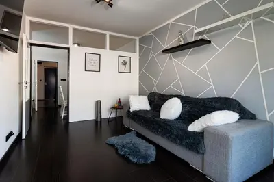 a living room with a couch and a wall at Tiger Deluxe Suite in Prague
