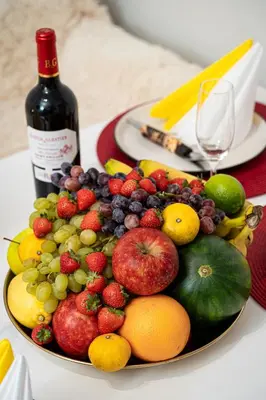 a plate of fruit on a table with a bottle of wine at Tiger Deluxe Suite in Prague