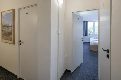 an empty room with two doors and a mirror at Cooliving in Prague