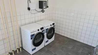 a washer and dryer sitting in a bathroom at Cooliving in Prague