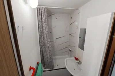 a small bathroom with a shower and a sink at Cooliving in Prague