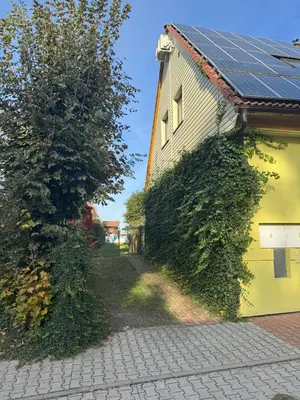 a house with solar panels on the side of it at Lochkov 53 in Prague